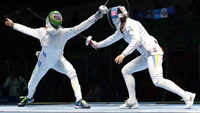 Nathalie Moellhausen of Brazil, left, competes against Yana Shemyakina of Ukraine during the women's epee team event at Carioca Arena 3 in the Rio 2016 Summer Olympic Games.
