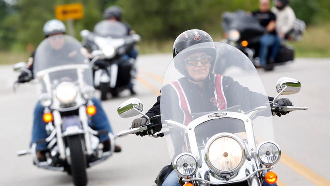 Sen. Joni Ernst (right) leads bikers along the route Saturday, Aug. 27, 2016, as they make their way to the Iowa State Fairgrounds for the second annual Roast and Ride fundraiser in Des Moines.