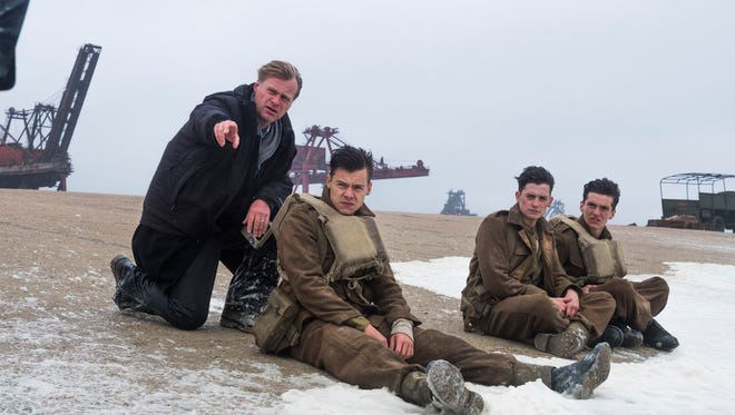 Christopher Nolan talks to his young 'Dunkirk' soldiers (from left) Harry Styles, Aneurin Barnard and Fionn Whitehead.