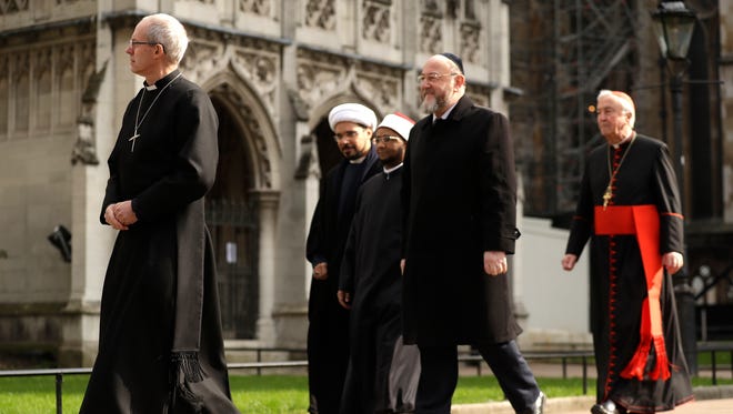 The Archbishop of Canterbury, Justin Welby, left, Sheikh Mohammad al Hilli, Sheikh Ezzat Khalifa, Chief Rabbi Ephriam Mirvis and Cardinal Vincent Nichols, Archbishop of Westminster, from left, arrive for a gathering of faith leaders take part in a vigil outside Westminster Abbey for the victims of Wednesday's attack.