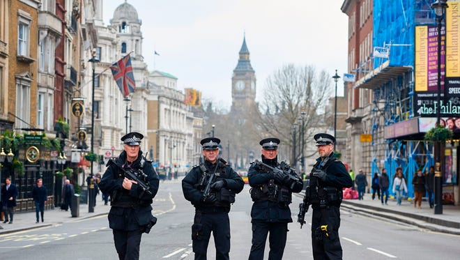 Armed police officers secure the area on Whitehall leading toward the Houses of Parliament in central London on March 23, 2017 the day after the March 22 terror attack in Westminster claimed at least three lives including that of police officer Keith Palmer. 
Britain's parliament reopened on Thursday with a minute's silence in a gesture of defiance a day after an attacker sowed terror in the heart of Westminster, killing three people before being shot dead. Sombre-looking lawmakers in a packed House of Commons chamber bowed their heads and police officers also marked the silence standing outside the headquarters of London's Metropolitan Police nearby.
 / AFP PHOTO / NIKLAS HALLE'NNIKLAS HALLE'N/AFP/Getty Images ORIG FILE ID: AFP_MX30F