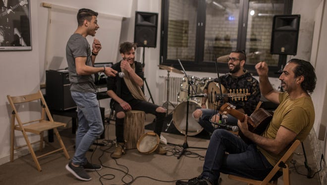 Musiqana band members Abdallah Rahal, Ali Hasan, Alaa Zaitouna and Adel Sabawi make jokes during a band practice at the Super Sessions cafe in Berlin. The Syrian band has been enchanting German audiences with traditional Arabic music.