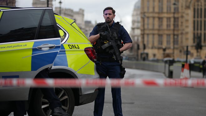 An armed police officer guards inside a police cordon outside the Houses of Parliament in central London on March 22, 2017 during an emergency incident.