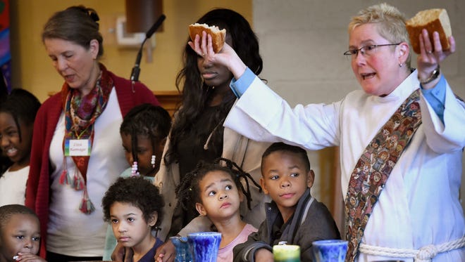 Deacon Beth Richardson breaks bread for the communion at Edgehill United Methodist Church in Nashville on Feb. 19, 2017. The church says becoming a sanctuary church is a big priority for its congregation.
