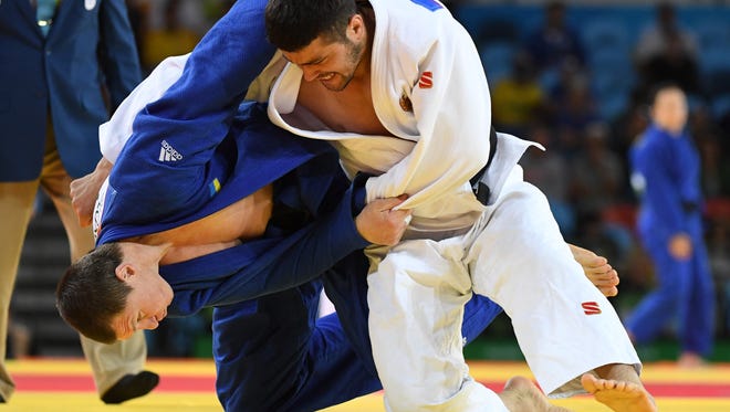 Soyib Kurbonov of Uzbekistan, right, and Artem Bloshenko of Ukraine compete in a men's 100kg elimination round judo contest at Carioca Arena 2 during the Rio 2016 Summer Olympic Games.