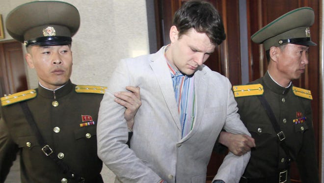 American student Otto Warmbier, center, is escorted at the Supreme Court in Pyongyang, North Korea, Wednesday, March 16, 2016. North Korea's highest court sentenced Warmbier, a 21-year-old University of Virginia undergraduate student, from Wyoming, Ohio, to 15 years in prison with hard labor on Wednesday for subversion. He allegedly attempted to steal a propaganda banner from a restricted area of his hotel at the request of an acquaintance who wanted to hang it in her church. (AP Photo/Jon Chol Jin) ORG XMIT: BKCD102