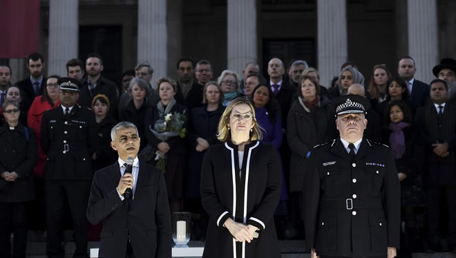 (L-R) The Mayor of London Sadiq Khan speaks as Home Secretary Amber Rudd MP and acting Commissioner of the Metropolitan Police Craig Mackey look on during a candlelit vigil at Trafalgar Square on March 23, 2017 in London.