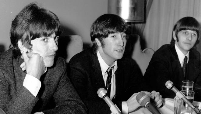 John Lennon, center, is flanked by bandmates George Harrison, left, and Ringo Starr as he apologizes for his remark that "The Beatles are more popular than Jesus" at a Chicago news conference on Aug. 11, 1966. They would play their final planned live concert less than three weeks later.