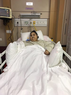 This handout photograph released by The Saifee Hospital on Thursday shows Egyptian patient Eman Ahmed Abd El Aty as she lies in a hospital bed at The Saifee Hospital in Mumbai, India.
Indian doctors said March Thursday that an Egyptian believed to be the world's heaviest woman had successfully undergone weight-loss surgery after losing over 100 kilogrammes (220 pounds).  E