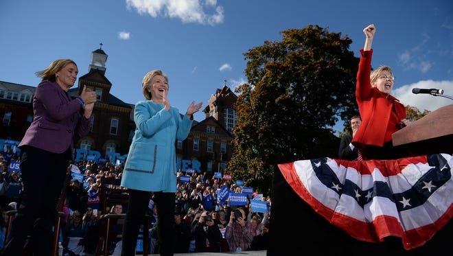 Massachusetts Sen. Elizabeth Warren speaks at a rally in Manchester, N.H., on Oct. 24, 2016, as Hillary Clinton and New Hampshire Gov. Maggie Hassan look on.