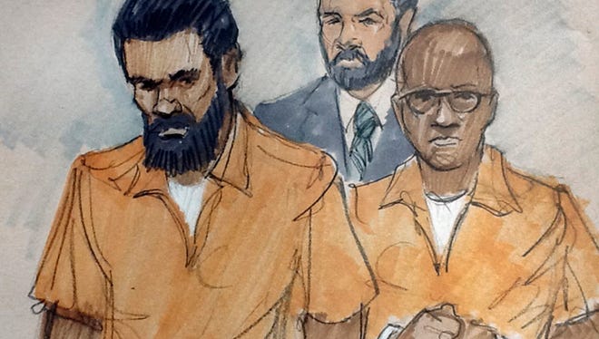 In this March 26, 2015, courtroom sketch, Jonas Edmonds, left, and his cousin Hasan Edmonds, right, stand in front of an FBI agent as they appear at a hearing at federal court in Chicago following their arrests on charges of conspiring with the Islamic State group.