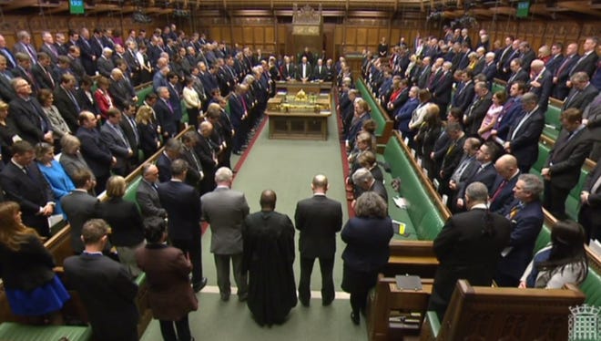 In a still image taken from footage broadcast by the UK Parliamentary Recording Unit (PRU) on March 23, 2017, shows members of parliament standing for a moment of silence. Britain's parliament reopened on Thursday after an attacker sowed terror in the heart of Westminster. Sombre-looking lawmakers in a packed House of Commons chamber bowed their heads and police officers also marked the silence standing outside the headquarters of London's Metropolitan Police nearby.