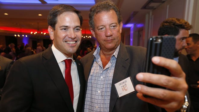 Sen. Marco Rubio, R-Fla., left, takes a selfie with George Sigalos during the Republican Party of Palm Beach County's 15th annual Lobsterfest on Aug. 18, 2016, in Boca Raton, Fla.