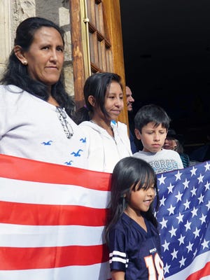 Jeanette Vizguerra of Denver poses with three of her U.S. citizen children — Zury, Luna and Roberto — in the doorway of the First Unitarian Society of Denver where she has taken sanctuary. Vizguerra, an undocumented immigrant, was worried that a regular meeting with U.S. immigration officials would result in her deportation.