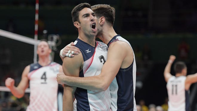 The United States volleyball team celebrates during the men's preliminary against Brazil.