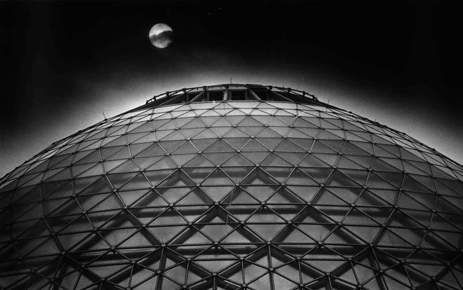 The moon is seen over the Mitchell Park Domes Horticulture Conservatory in 1983.