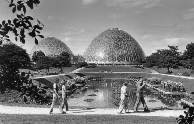 A 1984 Press Photo shows Mitchell Park visitors with the Horticulture Conservatory domes in the background.