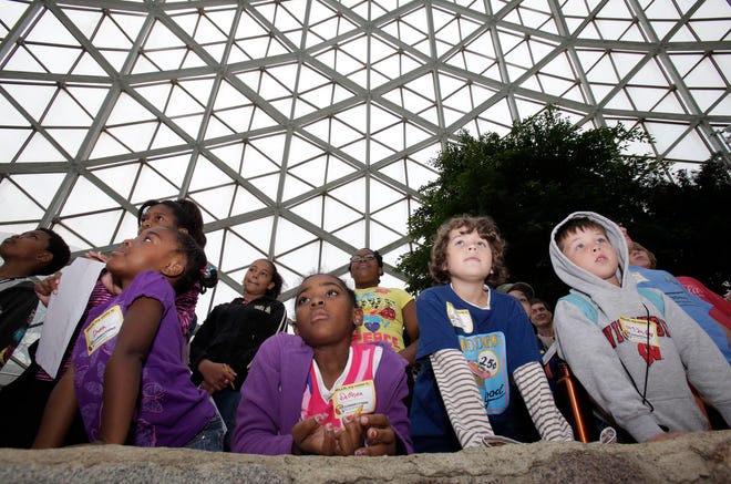 Dama Garrison, 4, (From left), her sister, DeOnna Garrison, 7, from Racine, Marcus Francis, 8, from Lake Mills, and Zeyden Chapin, 6, of Fond du Lac listen to a presentation at the Mitchell Park Domes on September 20, 2010.