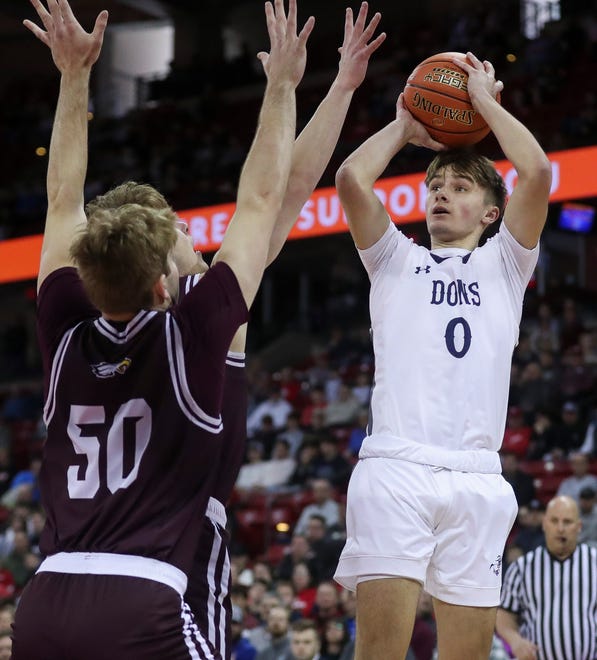 Columbus Catholic High School's Emmitt Konieczny (0) shoots the ball against Solon Springs High School in a Division 5 semifinal game during the WIAA state boys basketball tournament on Friday, March 15, 2024 at the Kohl Center in Madison, Wis. Columbus Catholic won the game, 78-65.