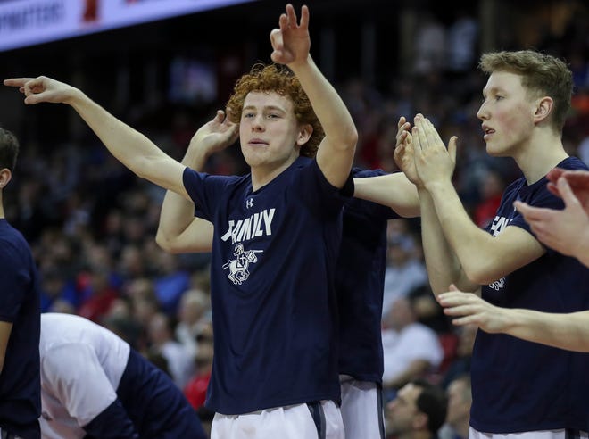 Columbus Catholic High School's Nathan Nemitz (left) celebrates on the bench after a made 3-pointer against Solon Springs High School in a Division 5 semifinal game during the WIAA state boys basketball tournament on Friday, March 15, 2024 at the Kohl Center in Madison, Wis. Columbus Catholic won the game, 78-65.