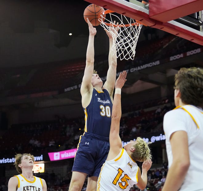 Marquette's Cade Kohnen (30) scores over Kettle Moraine's Teig Kowalski (15) during the first half of the WIAA Division 1 boys basketball state semifinal game on Friday March 15, 2024 at the Kohl Center in Madison, Wis.