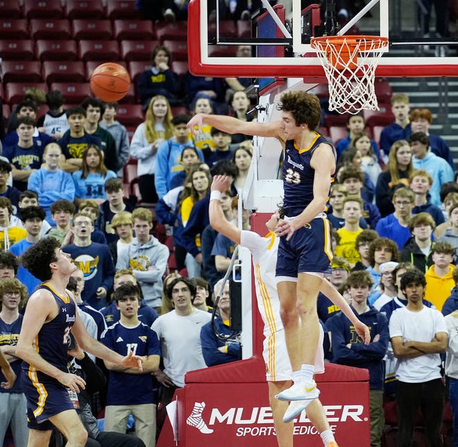 Marquette's Nolan Minessale (23) blocks the shot from Kettle Moraine's Ben Bestor (12) during the first half of the WIAA Division 1 boys basketball state semifinal game on Friday March 15, 2024 at the Kohl Center in Madison, Wis.
