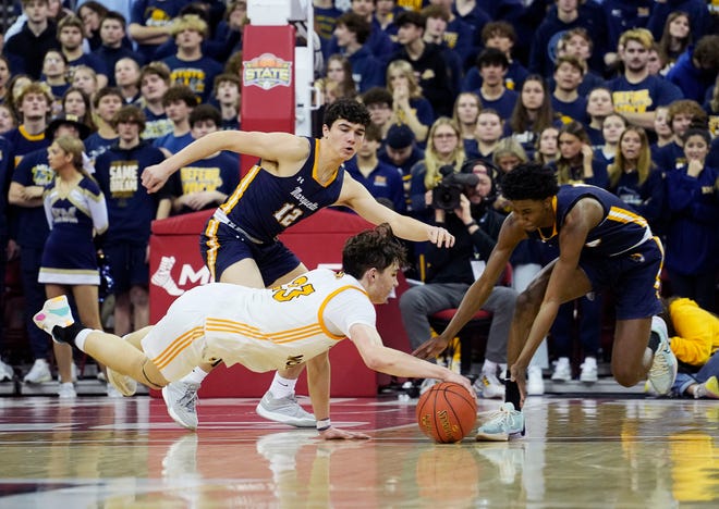 Kettle Moraine's Roman Thompson (23) and Marquette's Jeremiah Johnson (10) dive for the ball during the second half of the WIAA Division 1 boys basketball state semifinal game on Friday March 15, 2024 at the Kohl Center in Madison, Wis.
