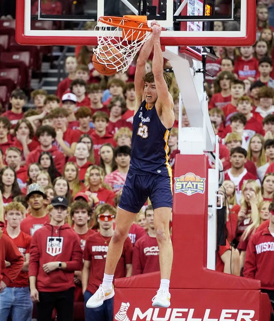Marquette's Nolan Minessale (23) dunks during the first half of the WIAA Division 1 boys basketball state championship game against Arrowhead on Saturday March 16, 2024 at the Kohl Center in Madison, Wis.