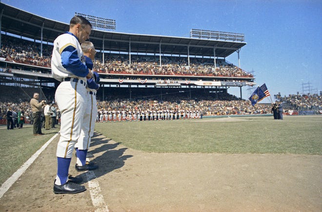 Brewers and Angels players line up along the baselines as the color guard presents flags for the National Anthem during the Brewers' first opening day on April 7, 1970. The game was also the season opener for the Brewers. A crowd of 37,237 saw the Brewers fall to the California Angels 12-0.