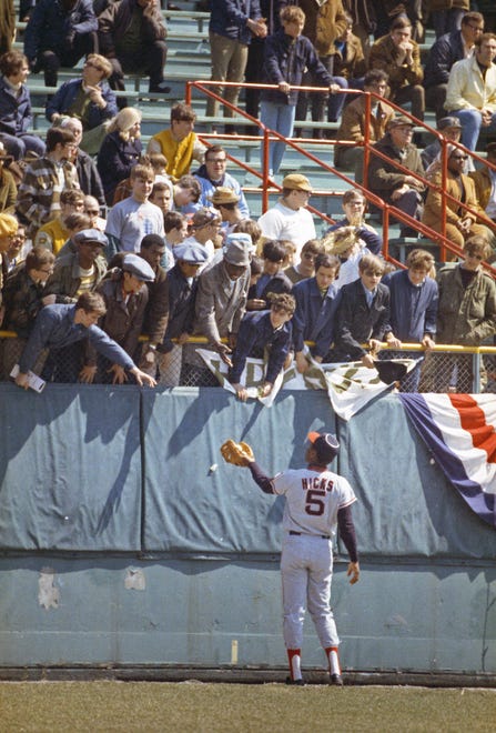 California Angles player Jim Hicks tosses balls to fans in the outfield during the Brewers' first opening day on April 7, 1970. The game was also the season opener for the Brewers. A crowd of 37,237 saw the Brewers fall to the California Angels 12-0.