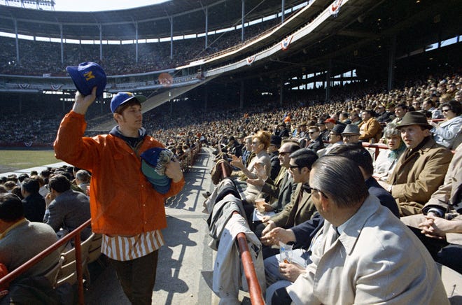 A concessions worker sells Brewers merchandise during the Brewers' first opening day on April 7, 1970. The game was also the season opener for the Brewers. A crowd of 37,237 saw the Brewers fall to the California Angels 12-0.