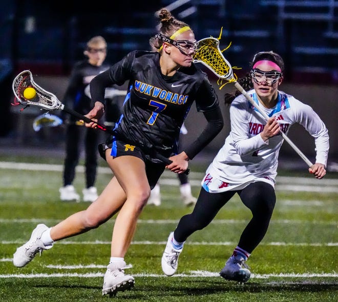 Mukwonago's Delaney Searing (7) races downfield with Arrowhead's Camila Obayashi (1) during the match at Arrowhead on Thursday, April 4, 2024.