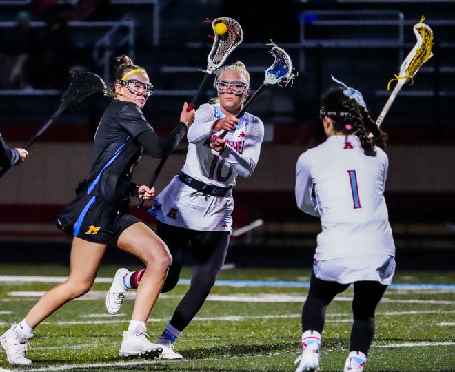 Mukwonago's Delaney Searing, left, works to get past Arrowhead's Katie Curry (10) and Camila Obayashi (1) during the match at Arrowhead on Thursday, April 4, 2024.