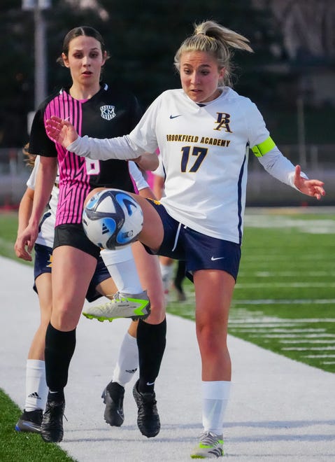 Brookfield Academy's Claire Tracy (17) traps a pass in front of Kettle Moraine's Riley Haertle (8) during the match at Kettle Moraine on Friday, April 5, 2024.