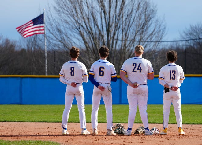 Germantown players pause for the national anthem prior to their game at home against Menomonee Falls on, Friday, April 12, 2024.