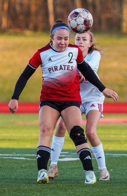 Pewaukee's Peyton Standing (2) battles for a header with Arrowhead's Ellie Pierson (4) during the match at Pewaukee, Friday, April 12, 2024.