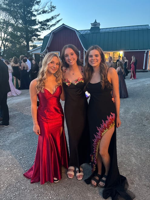 Hortonville High School juniors Elli Brantner (from left), Sydney Dent and Carolyn Tegge pose for a prom photo on Saturday, April 13, 2024, at Homestead Meadows Farm in Appleton.