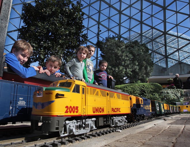 A group of children enjoy G-scale trains as the trains travel through a miniature landscape as part of The Circus Comes to Town at the Mitchell Park Conservatory in February, 2013.