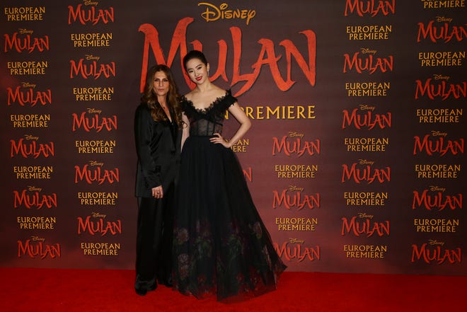 Actress Yifei Liu, right, and Director Niki Caro pose for photographers upon arrival at the European Premiere of 'Mulan' at a central London cinema, Thursday, March 12, 2020.